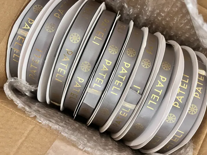 Custom grey ribbon rolls with gold print